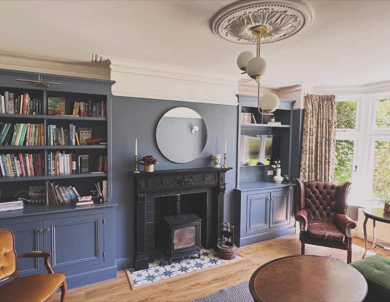 Fitted navy joinery around a period fireplace
