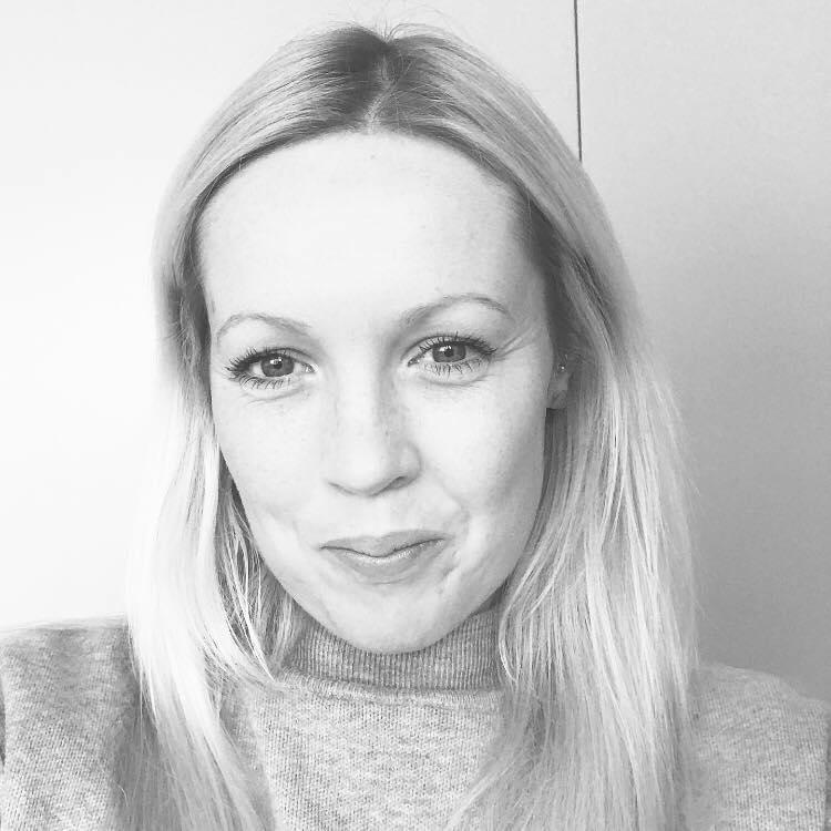 Black and white portrait of Hannah Fraher, founder of Hannah Fraher Interiors, smiling.